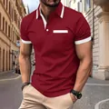 Detail view of men's burgundy polo shirt with white contrast pocket and collar accents - S / Tops / Red