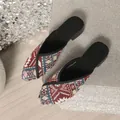 Detailed view of ethnic geometric pattern fabric on pointed toe mules - Burgundy