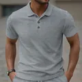 Detailed view of men's grey polo shirt featuring a premium jacquard fabric texture. - S / Tops / Gray