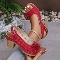 Detailed view of red chunky heel sandals with floral accents and laser-cut design - Red