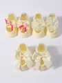 Close-up detail of three pairs of yellow infant socks with lace flowers and decorative bows - S (0-1 Year) / Bow/Flower Set / 3 Pairs Set / Yellow