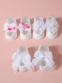 Detailed view of three pairs of white infant socks with bows and flowers on pink background. - S (0-1 Year) / Bow/Flower Set / 3 Pairs Set / White