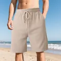Detail of men's beige heavy jacquard beach shorts with vertical texture and drawstring - Khaki