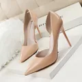 Elegant nude patent leather d'Orsay pumps with pointed toe and stiletto heels. - Nude