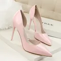Elegant pink patent leather stiletto pumps featuring a pointed toe and side cut-out design - Pink