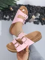 Close-up detail of pink double-strap cork slide sandals with adjustable metal buckles. - 36 / Pink
