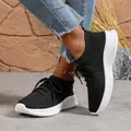 Detailed close-up of stylish black women's flyknit sneakers with chunky white soles - 36 / Black