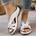 Close-up of white wedge sandals featuring 3D floral accents and elegant hollow patterns - 36 / White