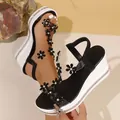 Detailed view of wedge sandals with floral patterns and sparkling rhinestone trim - 38 / Black and White Flowers
