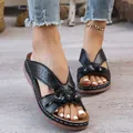 Detailed view of black platform wedge sandals featuring hollow-out patterns and flower accents - 36 / Black