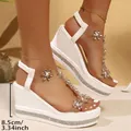 Close-up detail of white wedge sandals featuring rhinestone flower straps and 8.5cm heel - 36 / 3D Bow Rhinestone Style / White Gold (2512)