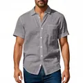 Close-up of men's grey linen short-sleeve shirt featuring textured fabric and chest pocket - S / Tops / Gray