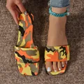 Detailed view of women's camouflage flat slides with vibrant orange and yellow patterns. - 36 / Yellow