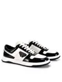 Modern black and white low-top leather sneakers featuring a stylish triangle badge detail - 38 / Black and White