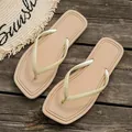 Top-down view of minimalist beige beach thong sandals on a rustic wooden background - 36/37 / Khaki