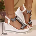 Detail view of white wedge sandals with butterfly motifs and rhinestone heels. - 36 / Bowknot Rhinestone Wedge Style (2511) / Black and White