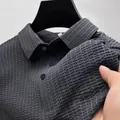 Close-up detail of grey business casual polo shirt showing seersucker texture - S / Tops / Gray
