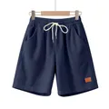 Volledig zicht op marineblauwe corduroy shorts aan een houten hanger op witte achtergrond - Marineblauw