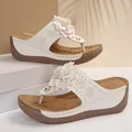 Elegant white women's wedge thong sandals featuring a decorative 3D flower and comfort sole - White