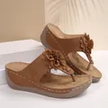 Brown wedge flip-flop sandals with elegant flower accent and contrast stitched details - Tan