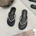 Elegant black flip-flop sandals with rhinestone straps for a sparkling summer look. - 35 / Black