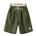 Close-up detail of olive green men's corduroy shorts featuring adjustable white drawstring - Army Green