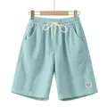 Macro view of corduroy texture and white drawstring on light blue casual shorts - Light Blue