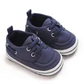Detailed macro view of navy blue baby canvas walking shoes featuring soft white soles - Inner Length 11cm / Dark Blue