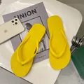 Detailed shot of vibrant yellow non-slip women's thong sandals on a modern background - Lemon Yellow