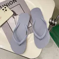 Macro view of stylish light purple anti-slip women's flip-flops on a white tray. - Haze Blue