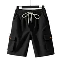 Full detail of black corduroy cargo shorts with elastic drawstring waist and side pockets. - Black