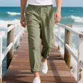 Men's olive green linen pants shown while walking on a sunny wooden pier outdoors - Army Green