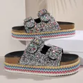 Detail of women's ethnic platform slides with silver glitter and colorful woven sole - Khaki