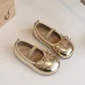 Elegant shiny gold Mary Jane shoes for girls featuring a bow and elastic strap closure - 23 / Gold