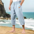 Side view of light blue linen cropped pants showing drawstring waist and leather label detail - Sky Blue