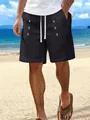 Detailed view of men's black cotton linen shorts with decorative buttons and drawstring. - S / Bottoms / Black
