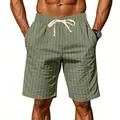 Detail shot of men's green striped linen shorts with white adjustable drawstring waist - S / Bottoms / Army Green