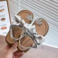 Shiny silver girls' princess sandals featuring a large bow and rhinestone flower detail - Size 26 (Inner Length 16.4cm) / Silver