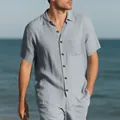 Casual men's light blue short sleeve button-down shirt with chest pocket on beach - S / Tops / Gray