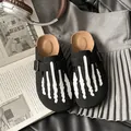 Black suede platform clogs for women featuring a white skeleton hand design on top - 35 / Black