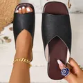 Detailed view of black leather flat slides with elegant V-shaped opening and square toe - 36 / Black