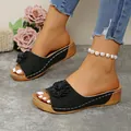 Elegant black wedge slide sandals with 3D flower detail and open toe design for women - Black