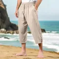 Close-up detail of beige cotton linen cropped beach pants with a drawstring waist - Khaki