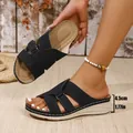 Close-up of black cross-strap wedge sandals highlighting the 4.5cm heel height detail. - Black