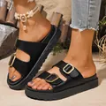 Close-up of black platform slide sandals with double gold buckles for women - Black