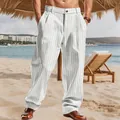 Detailed view of white vertical striped linen pants for men in a tropical beach setting - S / Bottoms / White