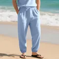 Detail of light blue linen joggers with drawstring waist and elastic ankle cuffs - S / Bottoms / Light Blue