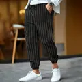 Detailed view of men's striped linen pants with white drawstring and pinstripe pattern - S / Bottoms / Black