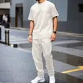 Detail view of men's heavy jacquard cream two-piece leisure set in urban street setting. - S / Top And Bottom / Khaki