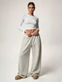 Close-up of grey wide-leg sweatpants with an elastic drawstring waist for a casual look - XS / Bottoms / Light Gray